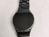 a watch that is sitting on a table next to a cell phone