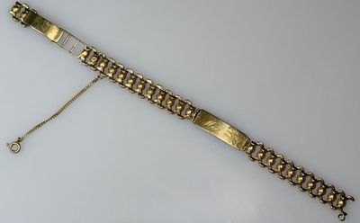 a close up of a gold bracelet on a white surface
