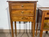 two wooden tables with drawers on them on a tiled floor