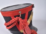 an image of a hat with a red tassel on top of it