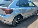 the rear end of a silver car parked in a parking lot