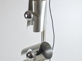 a lamp that is on top of a metal stand