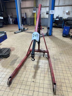 a picture of a red and black crane in a garage