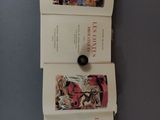 three books on a table with a button on it