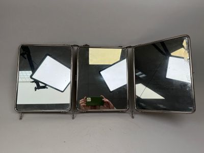 une personne en train de prendre une photo d'un miroir avec son téléphone portable