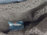 a teddy bear that is laying down on a blanket