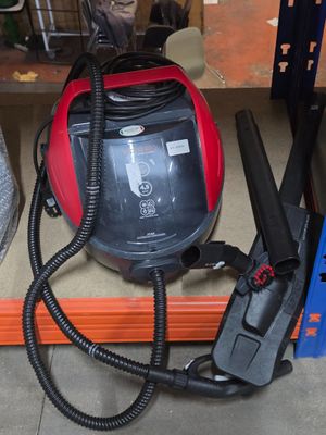 a red and black vacuum sitting on a shelf in a store