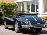 a black sports car parked in front of a house