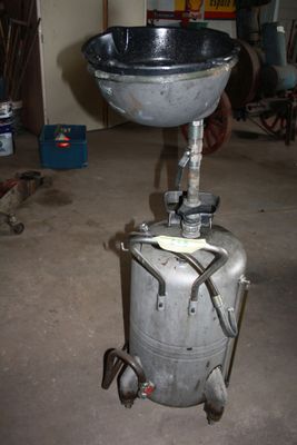 a large metal pot sitting on top of a metal tank