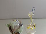 two glass figurines sitting on a glass table