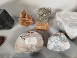 many different types of rocks on display in a glass case