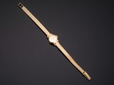 a gold watch on a black background