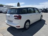 the back of a white minivan parked in a parking lot