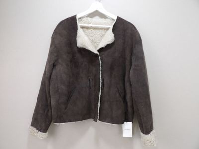 the jacket is hanging on a hanger on the wall