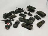 a lot of toy army vehicles on a white surface