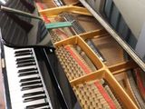 a piano that is sitting on a table in a living room