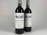 two bottles of wine sitting next to each other on a table