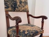 a wooden chair with a blue and green upholstered seat