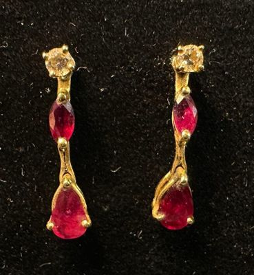 a pair of gold earrings with rub rub rub rub rub rub rub rub rub rub rub rub rub rub rub