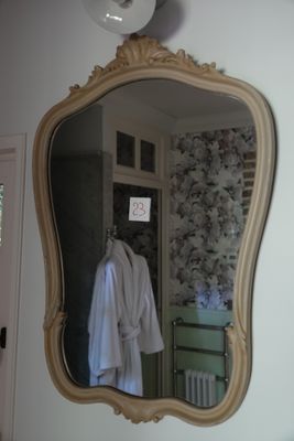 a mirror hanging on the wall above a sink