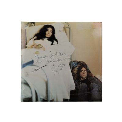 an old photo of a woman laying in a bed with a sign on it