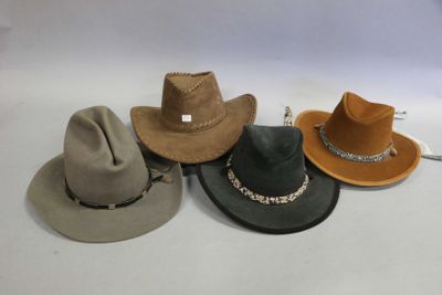 several hats are lined up in a row on a white surface