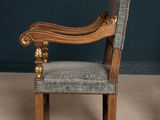 an old chair with a blue upholstered upholstered seat