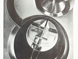 a black and white photo of a clock on a table
