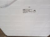 a white box sitting on top of a pile of papers