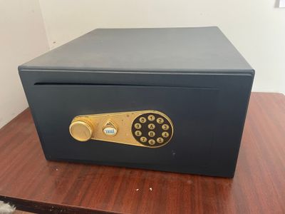 an open safe box sitting on top of a wooden table