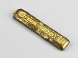 an old gold bar on a white surface
