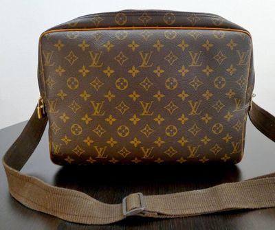 a brown and tan louis vuitton bag sitting on a table