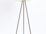 the floor lamp is made of metal and has a white shade on it