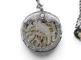 a necklace that has a picture of a horse in it