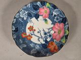 a plate with flowers on it sitting on a table
