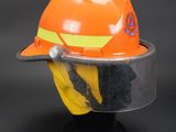 an orange hard hat with a safety visor on top of it