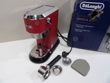 a red delonghi espresso coffee machine on a counter