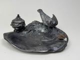 two birds sitting on top of a plate on a table