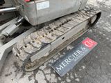 a sign on the ground near a bulldozer on the ground