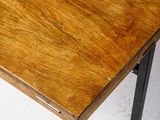 a wooden table with metal legs and a wooden top