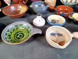 many bowls and spoons that are on a table