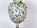 a glass vase with a floral design on it
