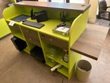 a desk with a computer on it in a room