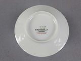 a white plate with a red and green design on it