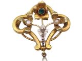an image of a gold brooch with a pearl and a flower