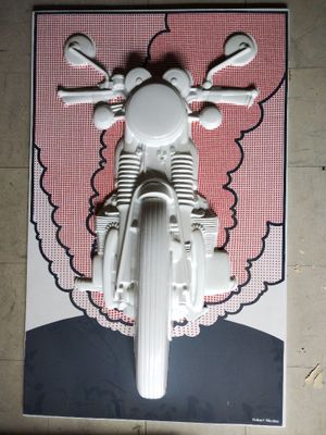 a poster of a motorcycle on the wall of a building