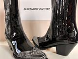 a pair of black ankle boots with crystals on them