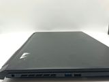 the back view of a laptop computer sitting on top of a white table