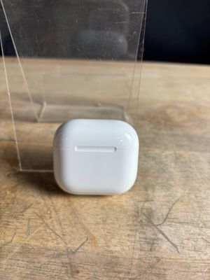 an apple airpods are sitting on top of a wooden table