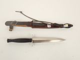 a knife and a knife holder on a white surface